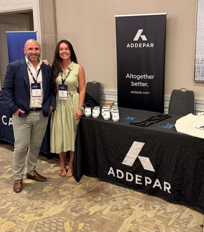 Addepar representatives beside a branded tabletop exhibit at the Focus Financial summit